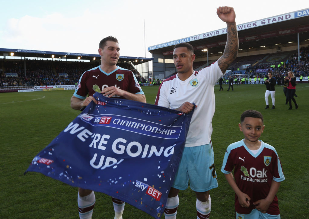 BURNLEY, UNITED KINGDOM - MAY 02: Sam Vokes (9) and Andre Gray of Burnley (7) celebrate as they are promoted to the Premier League after the Sky Bet Championship match between Burnley and Queens Park Rangers at Turf Moor on May 2, 2016 in Burnley, United Kingdom. Burnley defeated QPR 1-0 to gain promotion. (Photo by Jan Kruger/Getty Images)