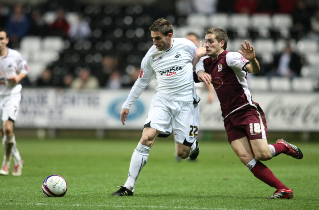SWANSEA, UNITED KINGDOM - DECEMBER 4: Angel Rangel of Swansea City holds off a challenge from Ryan Gilligan of Northampton Town during the Coca Cola League One Match between Swansea City and Northampton Town at The Liberty Stadium on December 4, 2007 in Swansea ,Wales. (Photo by Pete Norton/Getty Images)