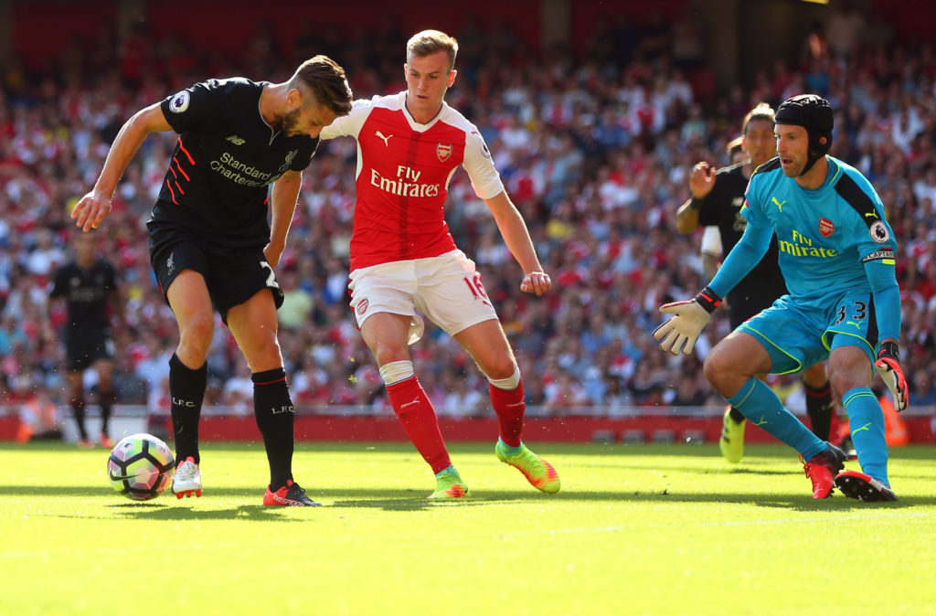 LONDON, ENGLAND - AUGUST 14: Adam Lallana of Liverpool back heels the ball as Rob Holding and Petr Cech of Arsenal look on during the Premier League match between Arsenal and Liverpool at Emirates Stadium on August 14, 2016 in London, England. (Photo by Catherine Ivill - AMA/Getty Images)