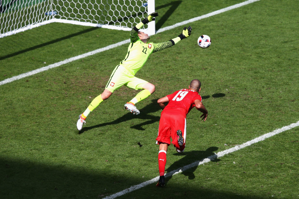 SAINT-ETIENNE, FRANCE - JUNE 25: Lukasz Fabianski of Poland saves the header by Eren Derdiyok of Switzerland during the UEFA EURO 2016 round of 16 match between Switzerland and Poland at Stade Geoffroy-Guichard on June 25, 2016 in Saint-Etienne, France. (Photo by Alex Livesey/Getty Images)