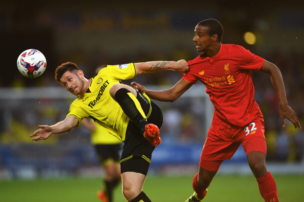 BURTON UPON TRENT, ENGLAND - AUGUST 23:  Calum Butcher of Burton Albion is challenged by Joel Matip of Liverpool during the EFL Cup second round match between Burton Albion and Liverpool at Pirelli Stadium on August 23, 2016 in Burton upon Trent, England.  (Photo by Gareth Copley/Getty Images)