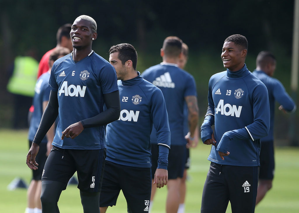 MANCHESTER, ENGLAND - AUGUST 12:  Paul Pogba and Marcus Rashford (R) of Manchester United share a joke during a first team training session at Aon Training Complex on August 12, 2016 in Manchester, England.  (Photo by Matthew Peters/Man Utd via Getty Images)