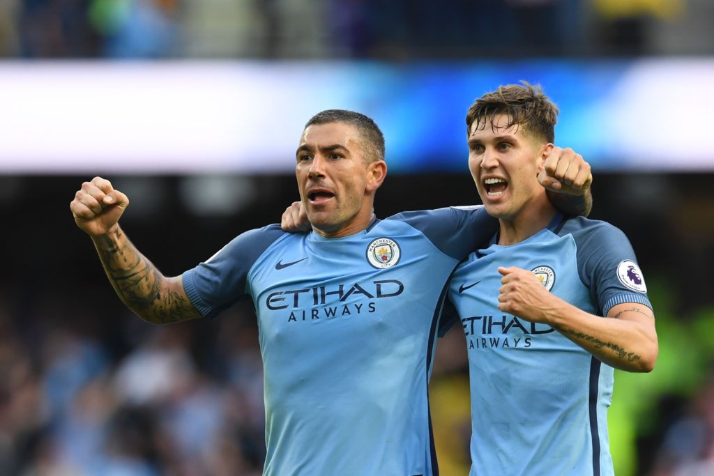 Manchester City's Serbian defender Aleksandar Kolarov (L) and Manchester City's English defender John Stones (R) celebrate Manchester City's second goal an own goal scored by Sunderland's Northern Irish defender Paddy McNair during the English Premier League football match between Manchester City and Sunderland at the Etihad Stadium in Manchester, north west England, on August 13, 2016. / AFP / PAUL ELLIS / RESTRICTED TO EDITORIAL USE. No use with unauthorized audio, video, data, fixture lists, club/league logos or 'live' services. Online in-match use limited to 75 images, no video emulation. No use in betting, games or single club/league/player publications.  /         (Photo credit should read PAUL ELLIS/AFP/Getty Images)
