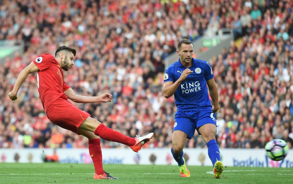 Leicester City's English midfielder Danny Drinkwater looks on as Liverpool's English midfielder Adam Lallana (L) shoots to score their third goal during the English Premier League football match between Liverpool and Leicester City at Anfield in Liverpool, north west England on September 10, 2016. / AFP / Paul ELLIS / RESTRICTED TO EDITORIAL USE. No use with unauthorized audio, video, data, fixture lists, club/league logos or 'live' services. Online in-match use limited to 75 images, no video emulation. No use in betting, games or single club/league/player publications. / (Photo credit should read PAUL ELLIS/AFP/Getty Images)
