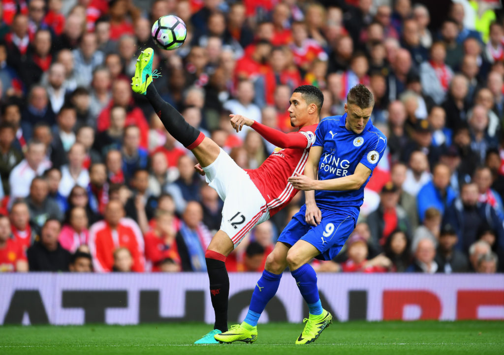 MANCHESTER, ENGLAND - SEPTEMBER 24:  Chris Smalling of Manchester United clears the ball while under pressure from Jamie Vardy of Leicester City during the Premier League match between Manchester United and Leicester City at Old Trafford on September 24, 2016 in Manchester, England.  (Photo by Laurence Griffiths/Getty Images)