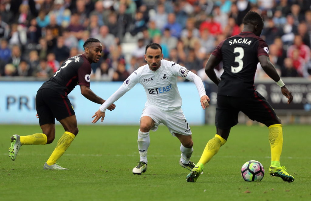 SWANSEA, WALES - SEPTEMBER 24: Leon Britton of Swansea City (C) against Raheem Sterling (L) and Bacary Sagna of Manchester City during the Premier League match between Swansea City and Manchester City at The Liberty Stadium on September 24, 2016 in Swansea, Wales. (Photo by Athena Pictures/Getty Images)