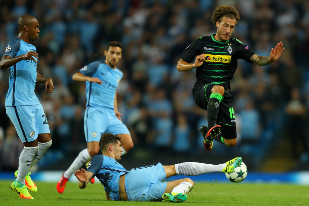 MANCHESTER, ENGLAND - SEPTEMBER 14: John Stones of Manchester City challenges Fabian Johnson of Borussia Moenchengladbach for the ball during the UEFA Champions League match between Manchester City FC and VfL Borussia Moenchengladbach at Etihad Stadium on September 14, 2016 in Manchester, England. (Photo by Richard Heathcote/Getty Images)