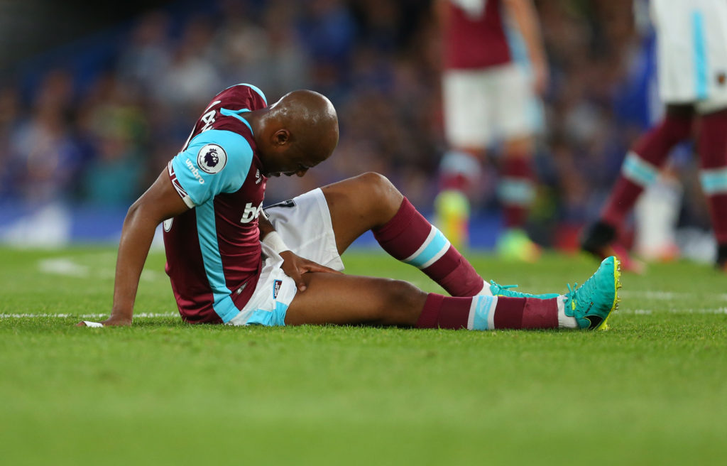 LONDON, ENGLAND - AUGUST 15: Andre Ayew of West Ham sits on the pitch with an injury during the Premier League match between Chelsea and West Ham United at Stamford Bridge on August 15, 2016 in London, England. (Photo by Catherine Ivill - AMA/Getty Images)
