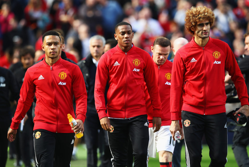 MANCHESTER, ENGLAND - OCTOBER 02:  (L/R) Memphis Depay of Manchester United, Anthony Martial of Manchester United, Marouane Fellaini of Manchester United make their way to the bench to take their seats for the match during the Premier League match between Manchester United and Stoke City at Old Trafford on October 2, 2016 in Manchester, England.  (Photo by Clive Brunskill/Getty Images)