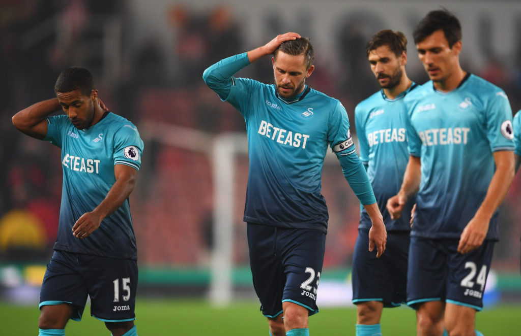 STOKE ON TRENT, ENGLAND - OCTOBER 31:  Wayne Routledge (15), Gylfi Sigurdsson (23) and Jack Cork of Swansea City (24) look dejected in defeat after the Premier League match between Stoke City and Swansea City at Bet365 Stadium on October 31, 2016 in Stoke on Trent, England.  (Photo by Laurence Griffiths/Getty Images)