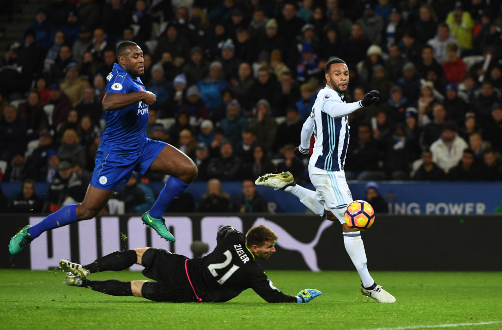 LEICESTER, ENGLAND - NOVEMBER 06:  Wes Morgan of Leicester City closes down Matt Phillips of West Bromwich Albion as he chips Ron-Robert Zieler of Leicester City to score his sides second goal during the Premier League match between Leicester City and West Bromwich Albion at The King Power Stadium on November 6, 2016 in Leicester, England.  (Photo by Ross Kinnaird/Getty Images)