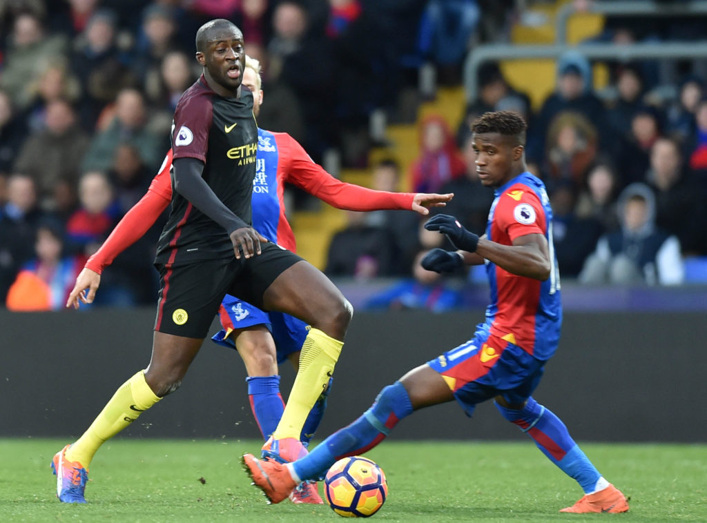 Manchester City's Ivorian midfielder Yaya Toure (L) passes the ball as Crystal Palace's Ivorian-born English striker Wilfried Zaha (R) tries to close him down during the English Premier League football match between Crystal Palace and Manchester City at Selhurst Park in south London on November 19, 2016. / AFP / OLLY GREENWOOD / RESTRICTED TO EDITORIAL USE. No use with unauthorized audio, video, data, fixture lists, club/league logos or 'live' services. Online in-match use limited to 75 images, no video emulation. No use in betting, games or single club/league/player publications. / (Photo credit should read OLLY GREENWOOD/AFP/Getty Images)
