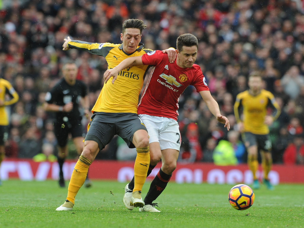 MANCHESTER, ENGLAND - NOVEMBER 19:  Mesut Ozil of Arsenal challenges Ander Herrera of Man Utd during the Premier League match between Manchester United and Arsenal at Old Trafford on November 19, 2016 in Manchester, England.  (Photo by David Price/Arsenal FC via Getty Images)