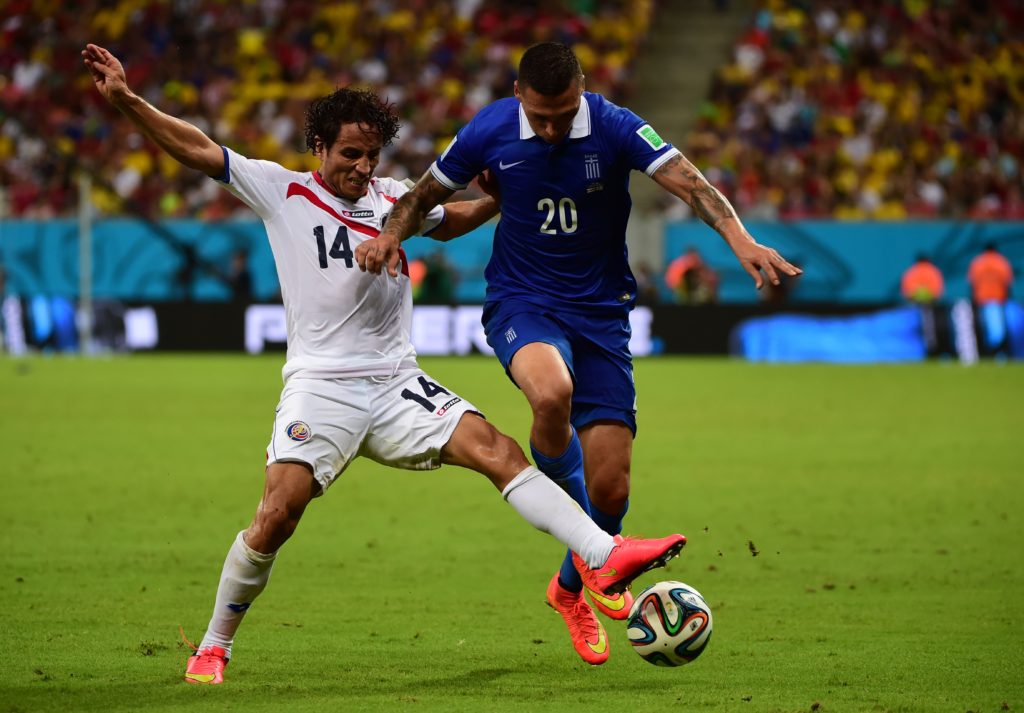 Greece's defender Jose Holebas (R) challenges Costa Rica's forward Randall Brenes during the round of 16 football match between Costa Rica and Greece at Pernambuco Arena in Recife during the 2014 FIFA World Cup on June 29, 2014. AFP PHOTO / RONALDO SCHEMIDT        (Photo credit should read RONALDO SCHEMIDT/AFP/Getty Images)