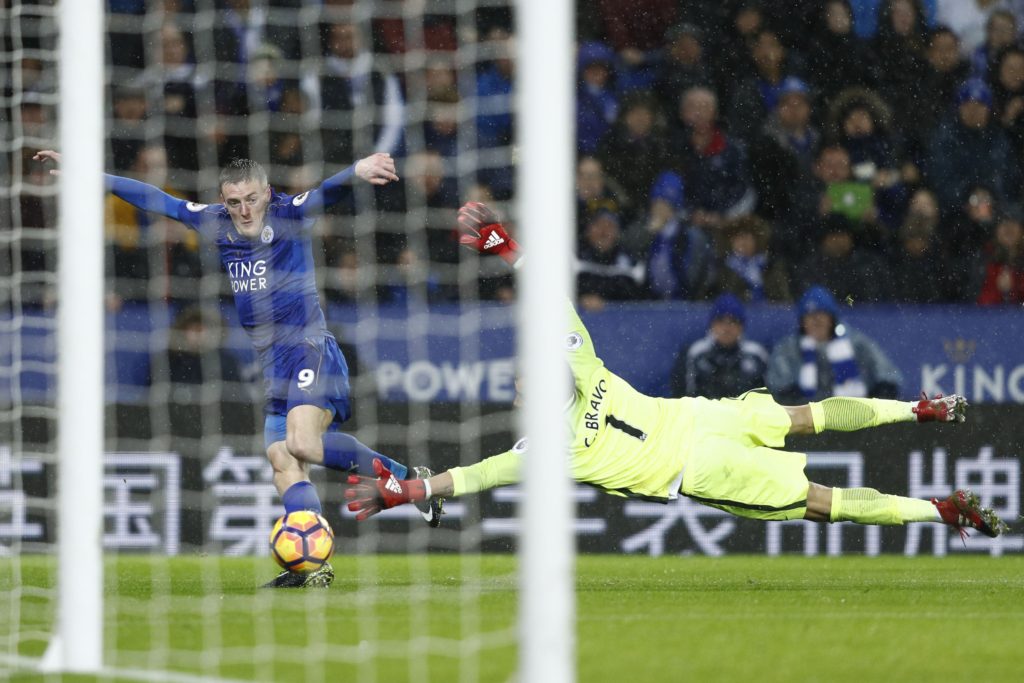 Leicester City's English striker Jamie Vardy (L) takes the ball around Manchester City's Chilean goalkeeper Claudio Bravo on his way to scoring his third goal, their fourth during the English Premier League football match between Leicester City and Manchester City at King Power Stadium in Leicester, central England on December 10, 2016. Leicester won the game 4-2. / AFP / Adrian DENNIS / RESTRICTED TO EDITORIAL USE. No use with unauthorized audio, video, data, fixture lists, club/league logos or 'live' services. Online in-match use limited to 75 images, no video emulation. No use in betting, games or single club/league/player publications.  /         (Photo credit should read ADRIAN DENNIS/AFP/Getty Images)