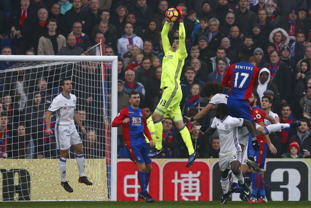 Chelsea's Belgian goalkeeper Thibaut Courtois (C) jumps to save a shot by Crystal Palace's Zaire-born Belgian striker Christian Benteke during the English Premier League football match between Crystal Palace and Chelsea at Selhurst Park in south London on December 17, 2016. / AFP / Adrian DENNIS / RESTRICTED TO EDITORIAL USE. No use with unauthorized audio, video, data, fixture lists, club/league logos or 'live' services. Online in-match use limited to 75 images, no video emulation. No use in betting, games or single club/league/player publications. / (Photo credit should read ADRIAN DENNIS/AFP/Getty Images)