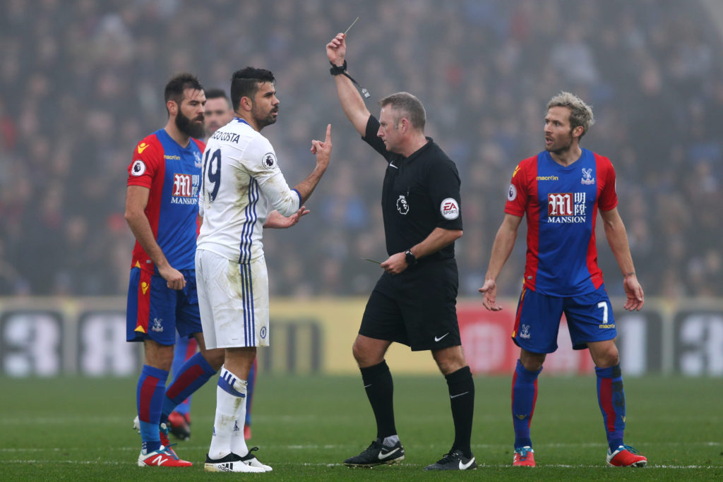 LONDON, ENGLAND - DECEMBER 17: Diego Costa of Chelsea (L) is shown a yellow card by Referee Jonathan Moss (C) during the Premier League match between Crystal Palace and Chelsea at Selhurst Park on December 17, 2016 in London, England. (Photo by Clive Rose/Getty Images)