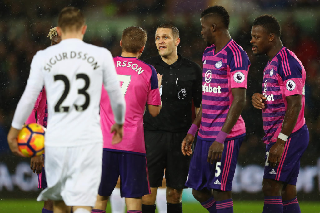 SWANSEA, WALES - DECEMBER 10:  Referee Craig Pawson is surrounded by Sebastian Larsson, Papy Djilobodji (2R) and Lamine Kone (R) of Sunderland  after awarding a penalty during the Premier League match between Swansea City and Sunderland at the Liberty Stadium on December 10, 2016 in Swansea, Wales.  (Photo by Michael Steele/Getty Images)