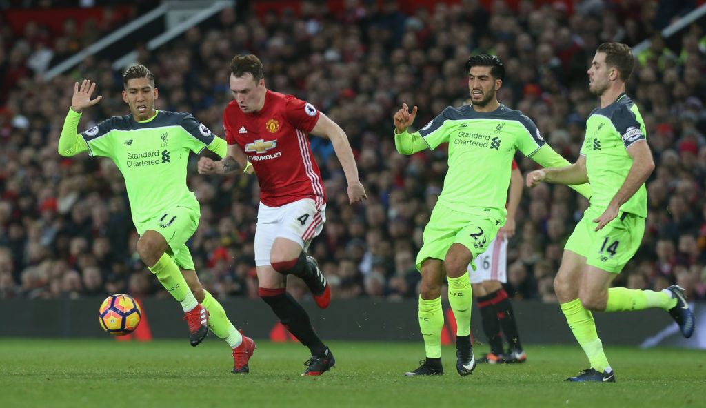 MANCHESTER, ENGLAND - JANUARY 15: Phil Jones of Manchester United in action with Roberto Firmino and Emre Can of Liverpool during the Premier League match between Manchester United and Liverpool at Old Trafford on January 15, 2017 in Manchester, England. (Photo by Tom Purslow/Man Utd via Getty Images)