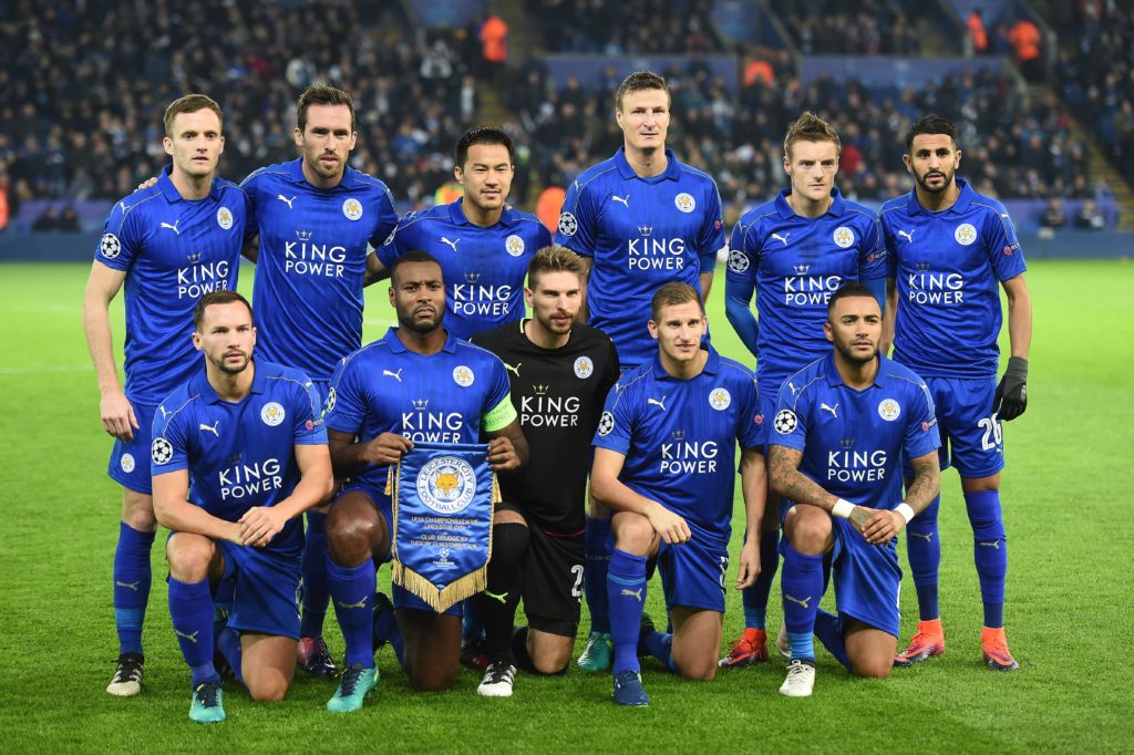 Back row L-R: Leicester City's Welsh midfielder Andy King, Leicester City's Austrian defender Christian Fuchs, Leicester City's Japanese striker Shinji Okazaki, Leicester City's German defender Robert Huth, Leicester City's English striker Jamie Vardy and Leicester City's Algerian midfielder Riyad Mahrez, and Front Row L-R: Leicester City's English midfielder Danny Drinkwater, Leicester City's English-born Jamaican defender Wes Morgan, Leicester City's German goalkeeper Ron-Robert Zieler, Leicester City's English midfielder Marc Albrighton and Leicester City's English defender Danny Simpson, pose for a team photo ahead of the UEFA Champions League group G football match between Leicester City and Club Brugge at the King Power Stadium in Leicester, central England on November 22, 2016. Leicester won the match 2-1. / AFP / Paul ELLIS (Photo credit should read PAUL ELLIS/AFP/Getty Images)