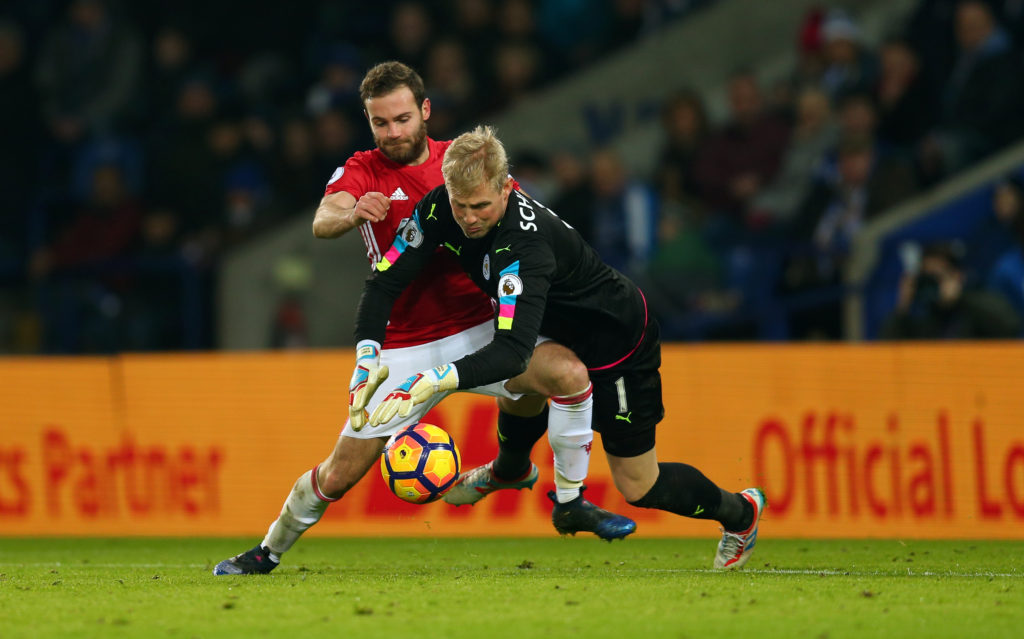 LEICESTER, ENGLAND - FEBRUARY 05: Juan Mata of Manchester United tries to take advantage as Leicester City goalkeeper Kasper Schmeichel fumbles the ball during the Premier League match between Leicester City and Manchester United at The King Power Stadium on February 5, 2017 in Leicester, England. (Photo by Catherine Ivill - AMA/Getty Images)