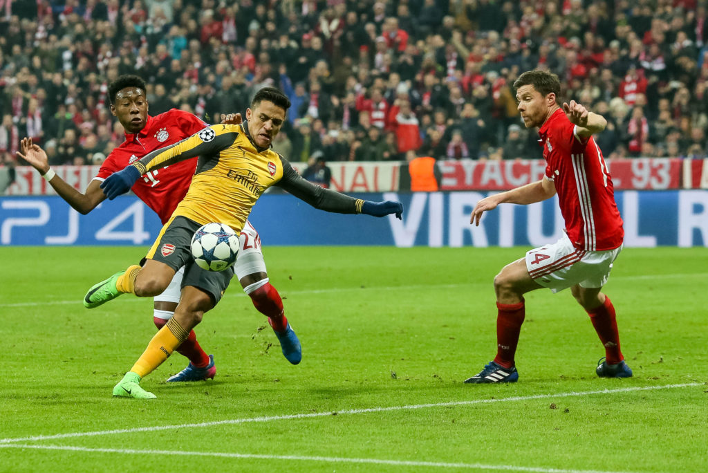 MUNICH, GERMANY - FEBRUARY 15: Alexis Sanchez of Arsenal and David Alaba of Munich , Xabi Alonso of Munich battle for the ball during the UEFA Champions League Round of 16 first leg match between FC Bayern Muenchen and Arsenal FC at Allianz Arena on February 15, 2017 in Munich, Germany. (Photo by TF-Images/Getty Images)