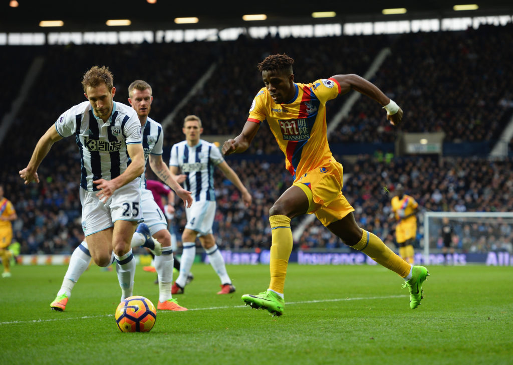 WEST BROMWICH, ENGLAND - MARCH 04: Wilfried Zaha of Crystal Palace and Craig Dawson of West Bromwich Albion close in on the ball during the Premier League match between West Bromwich Albion and Crystal Palace at The Hawthorns on March 4, 2017 in West Bromwich, England.  (Photo by Tony Marshall/Getty Images)