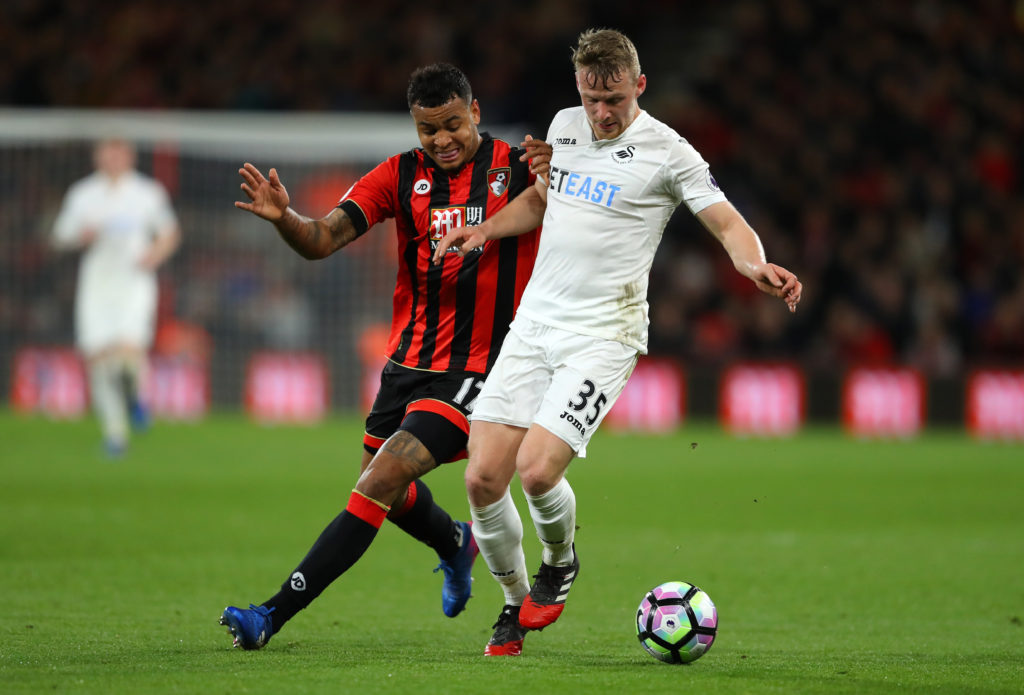 BOURNEMOUTH, ENGLAND - MARCH 18:  Joshua King of AFC Bournemouth (L) and Stephen Kingsley of Swansea City (R) battle for possession during the Premier League match between AFC Bournemouth and Swansea City at Vitality Stadium on March 18, 2017 in Bournemouth, England.  (Photo by Warren Little/Getty Images)