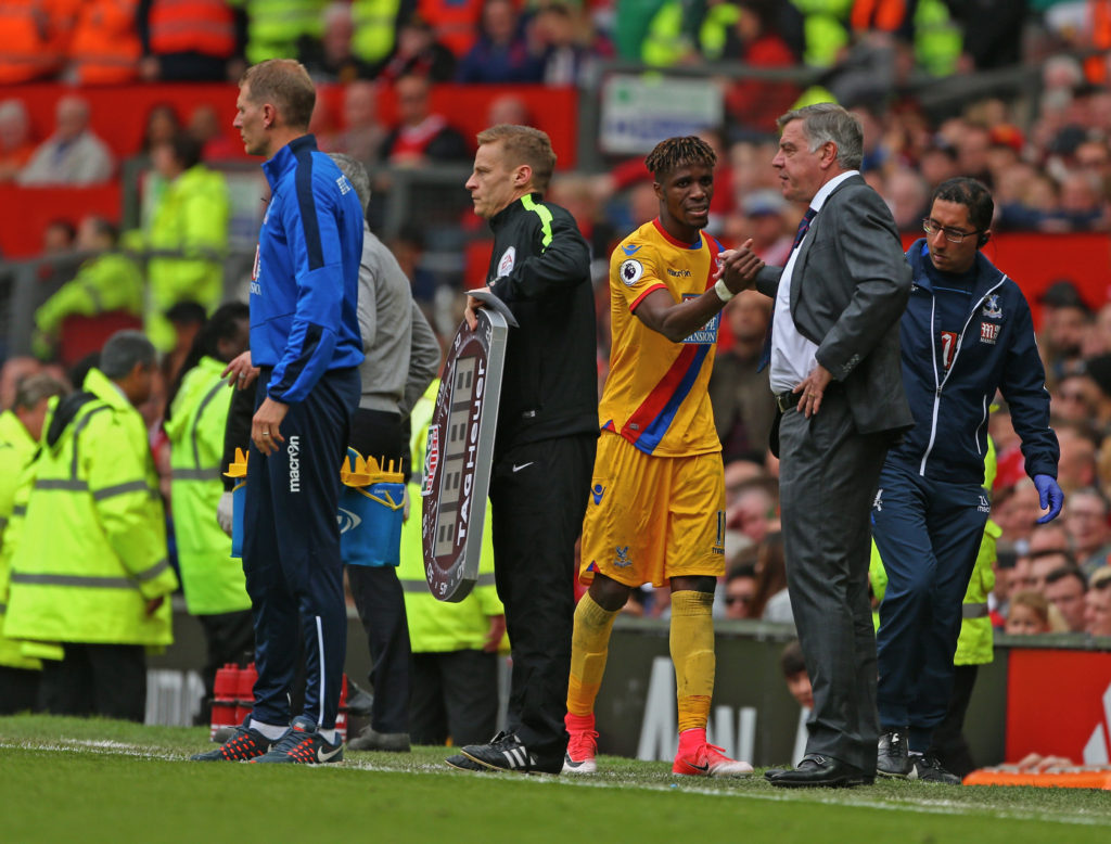 MANCHESTER, ENGLAND - MAY 21: Wilfried Zaha of Crystal Palace shakes hands with  Sam Allardyce, Manager of Crystal Palace after leaving the pitch from injury during the Premier League match between Manchester United and Crystal Palace at Old Trafford on May 21, 2017 in Manchester, England.  (Photo by Dave Thompson/Getty Images)