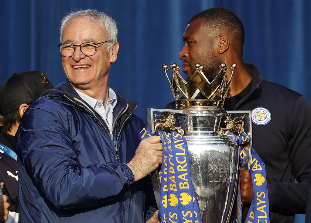 Leicester City's Italian manager Claudio Ranieri (L) and Leicester City's English defender Wes Morgan hold the Premier league trophy as the Leicester City football team celebrate in Victoria Park, after taking part in an open-top bus parade through Leicester, to celebrate winning the Premier League title on May 16, 2016. / AFP / ADRIAN DENNIS (Photo credit should read ADRIAN DENNIS/AFP/Getty Images)