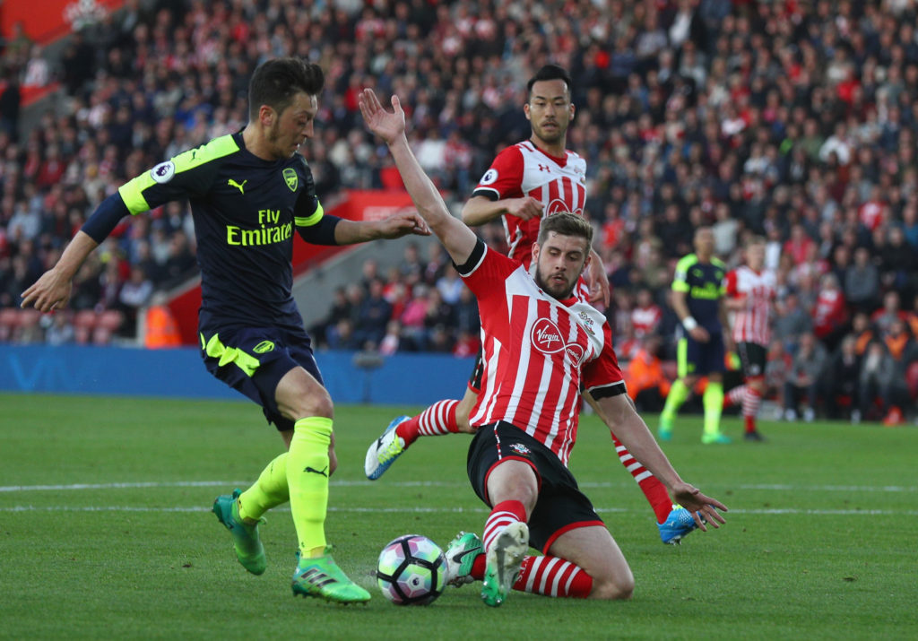 SOUTHAMPTON, ENGLAND - MAY 10: Mesut Oezil of Arsenal is tackled by Jack Stephens of Southampton during the Premier League match between Southampton and Arsenal at St Mary's Stadium on May 10, 2017 in Southampton, England. (Photo by Ian Walton/Getty Images)