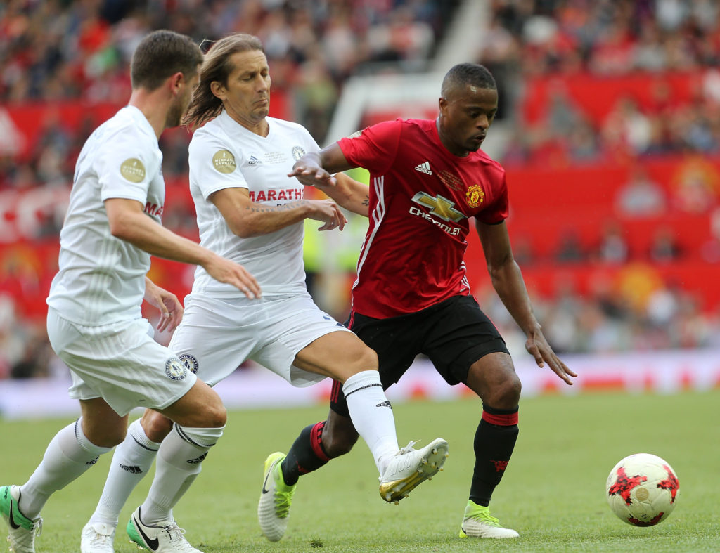 MANCHESTER, ENGLAND - JUNE 04: Patrice Evra of Manchester United '08 XI in action with Michel Salgado of Michael Carrick All-Stars during the Michael Carrick Testimonial match between Manchester United '08 XI and Michael Carrick All-Stars at Old Trafford on June 4, 2017 in Manchester, England. (Photo by John Peters/Man Utd via Getty Images)